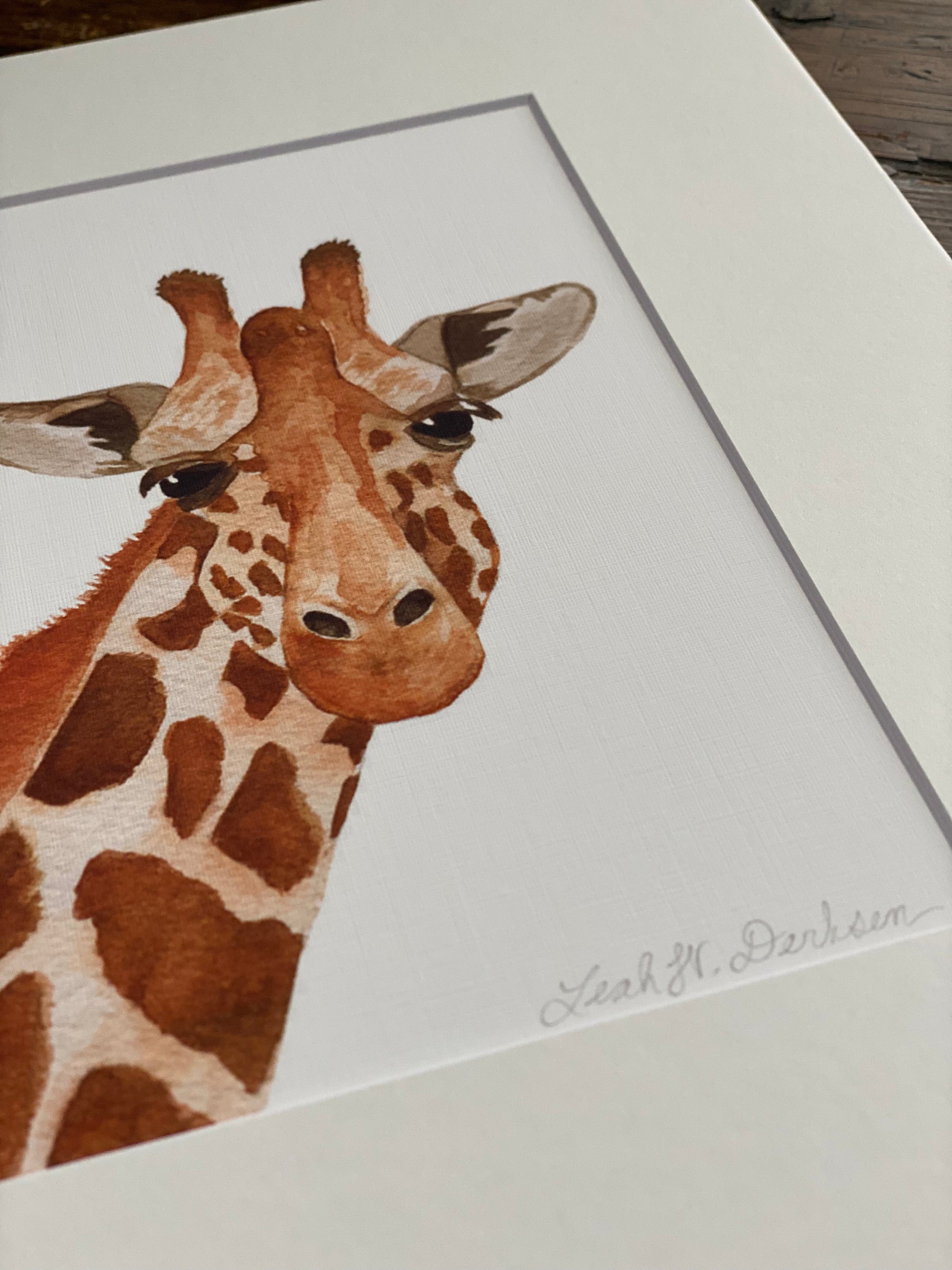 closeup of giraffe watercolor print including artist's signature.