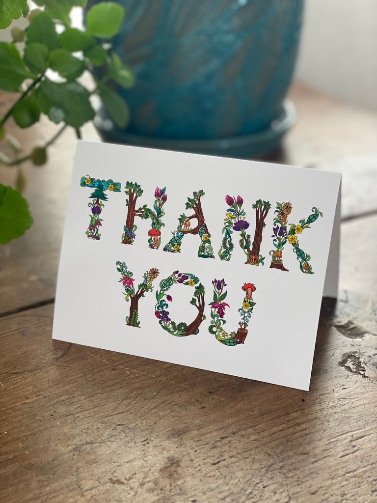greeting card with botanical alphabet spelling the words thank you.