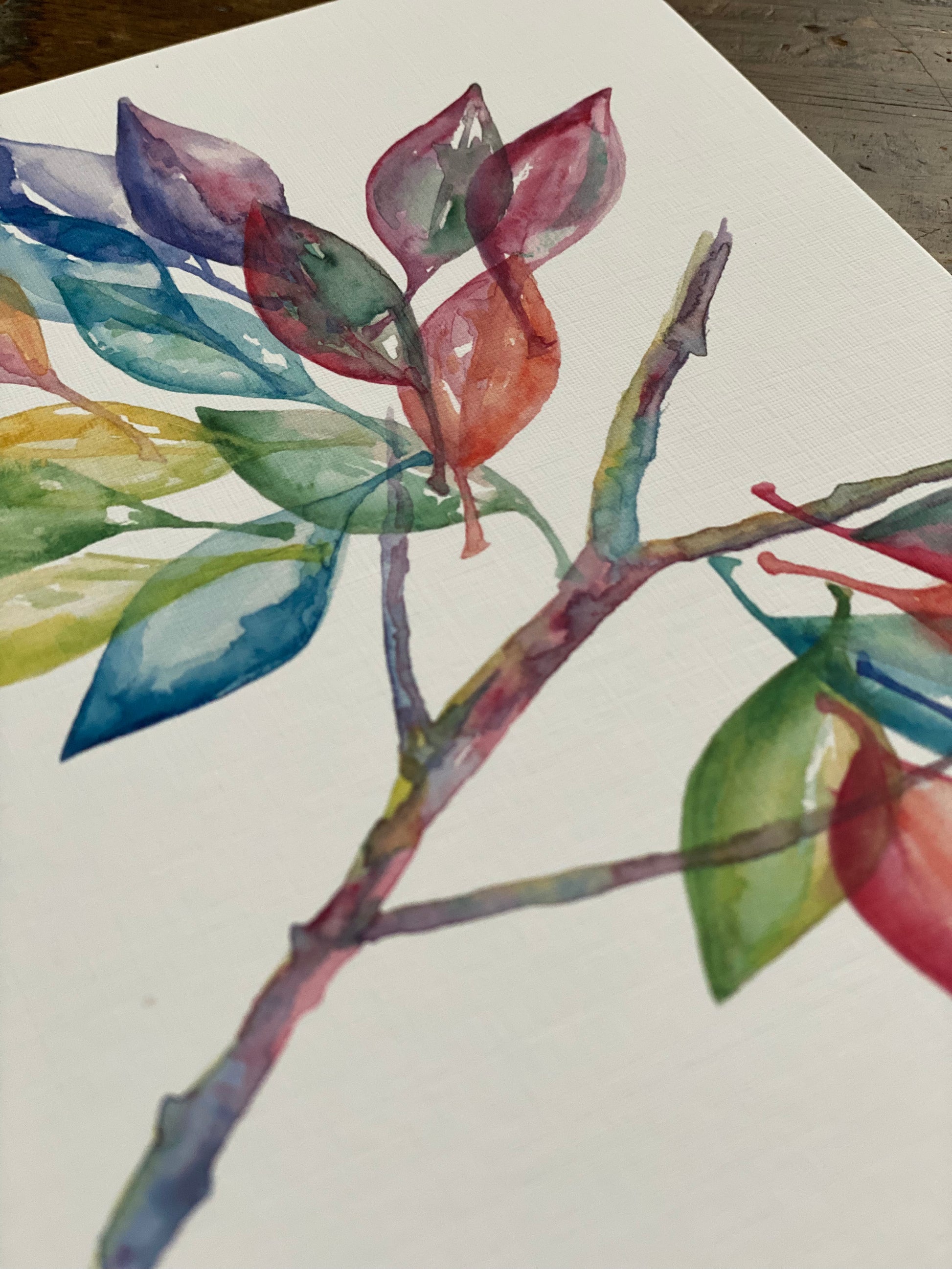 5x7 greeting card with a watercolor painting of multi-colored leaves on a branch.