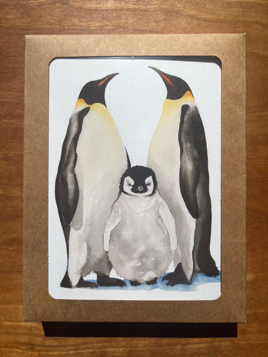 A package of greeting cards with a watercolor painting of an emperor penguin family.