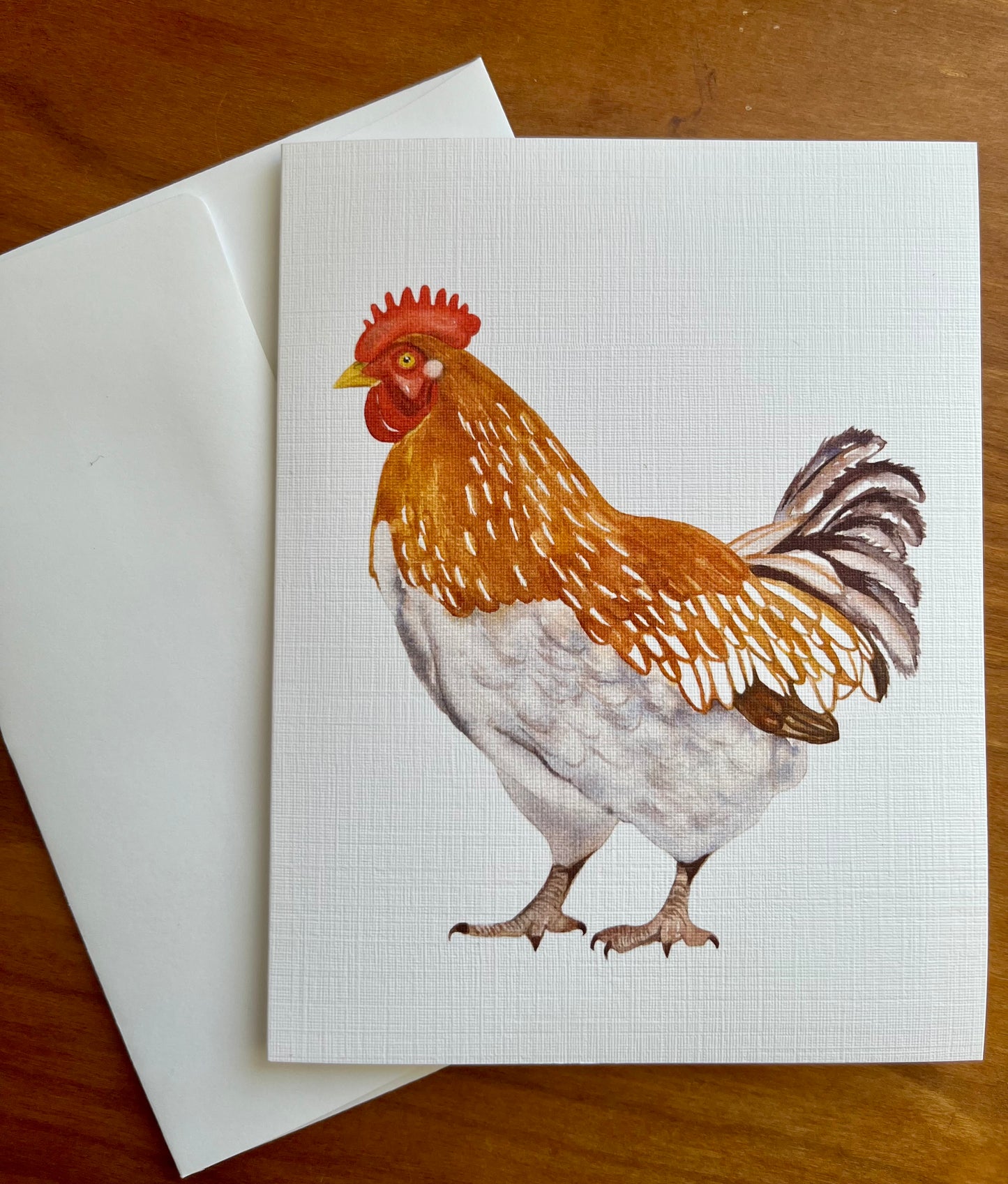 Greeting card with a watercolor painting of a brown and white chicken.