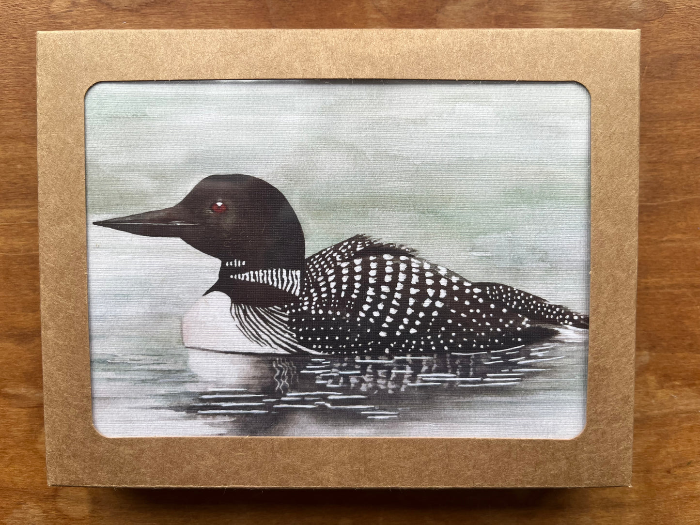 Kraft box containing greeting cards with a watercolor painting of a loon.