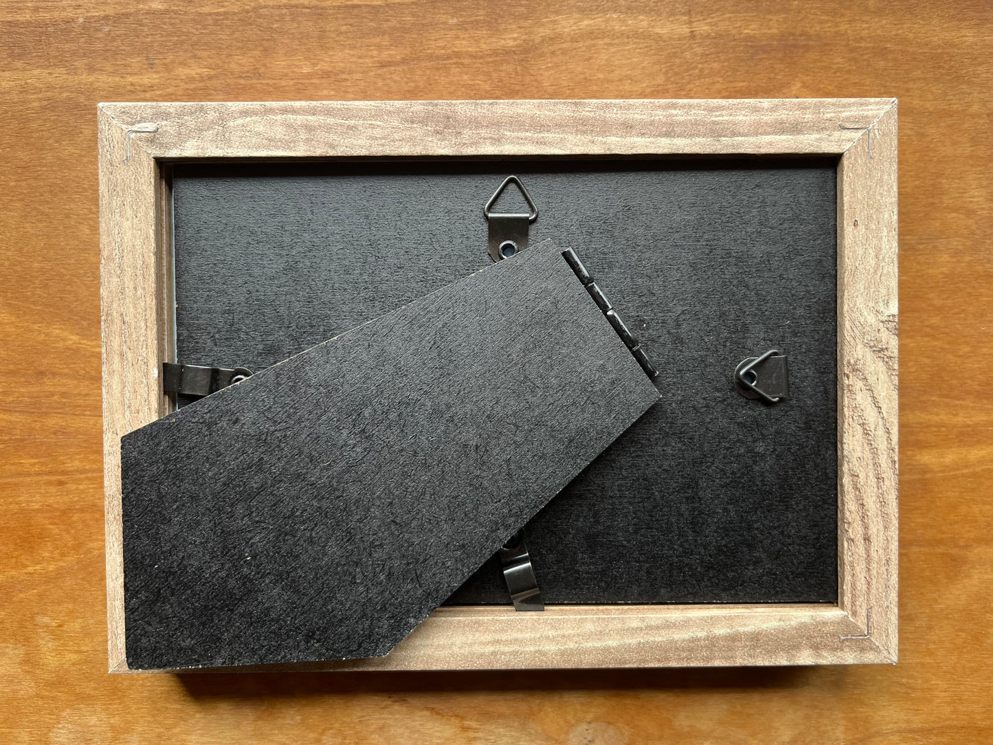 The back of a light brown picture frame.