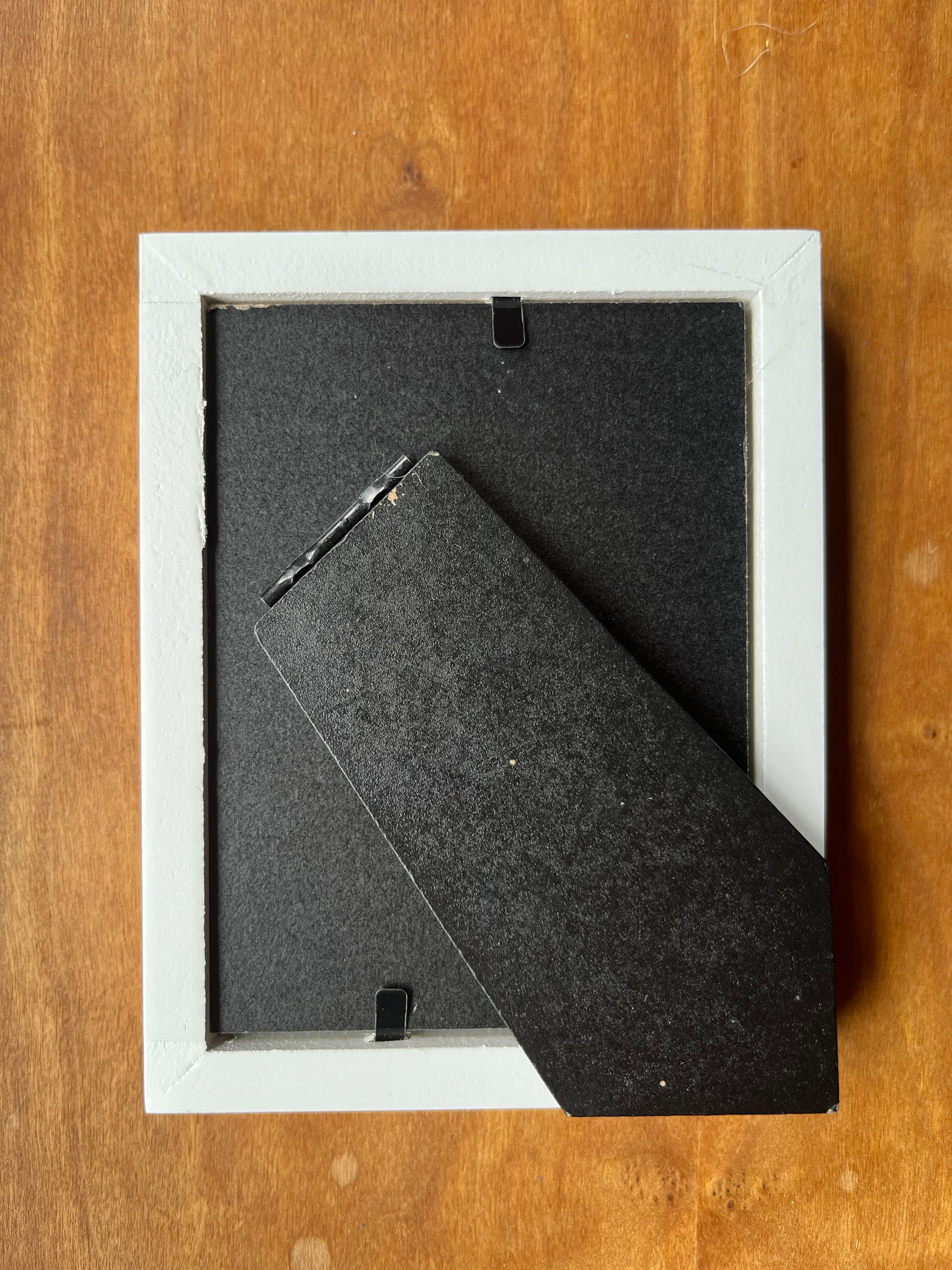 Back of a white picture frame.