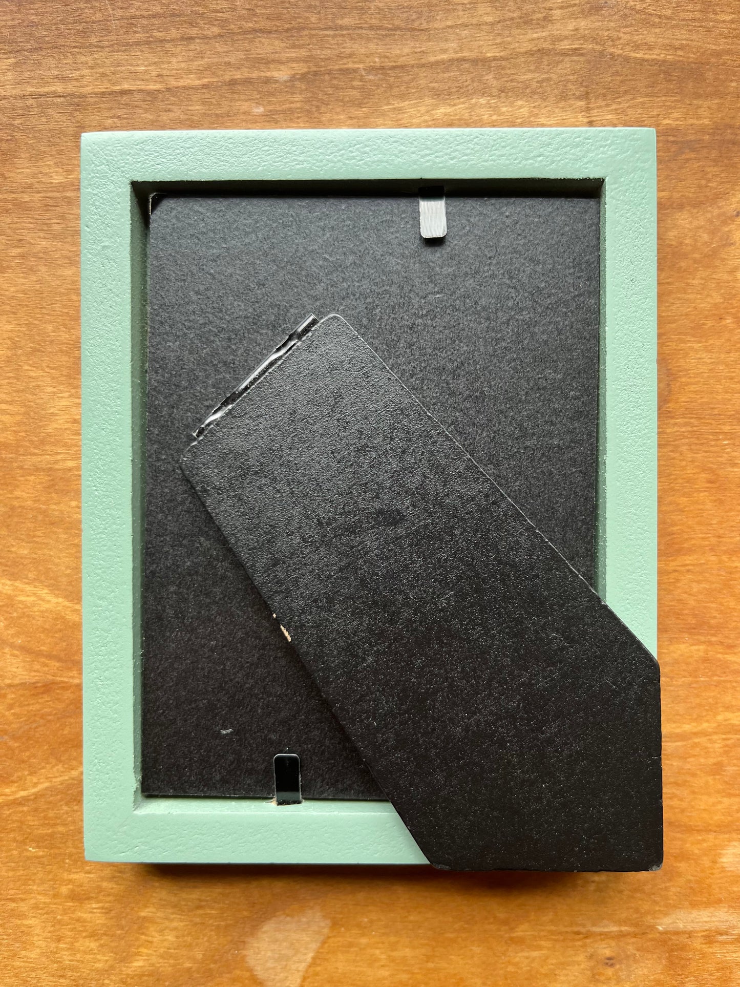 Back of a green picture frame.