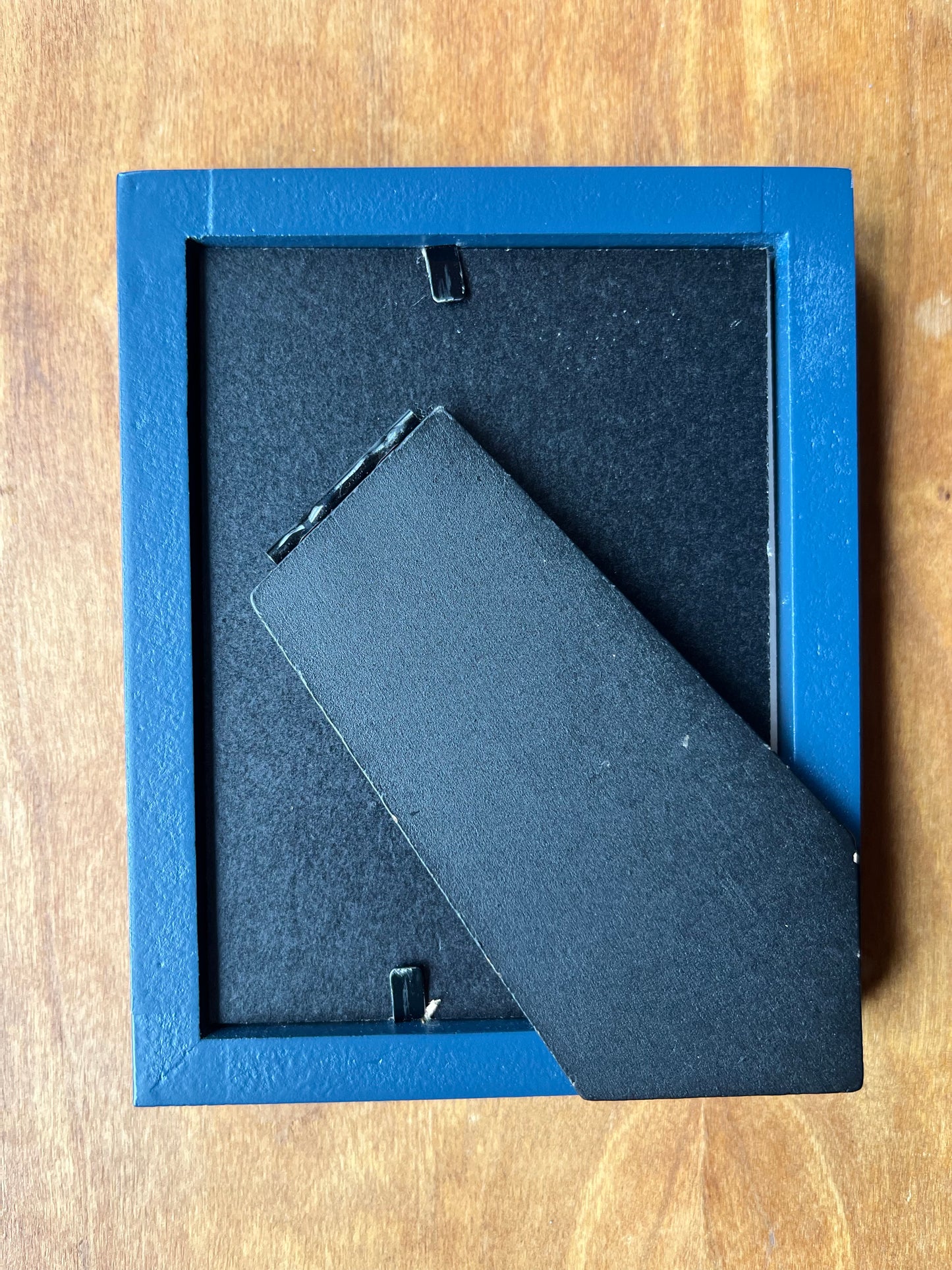 Back of a blue picture frame.