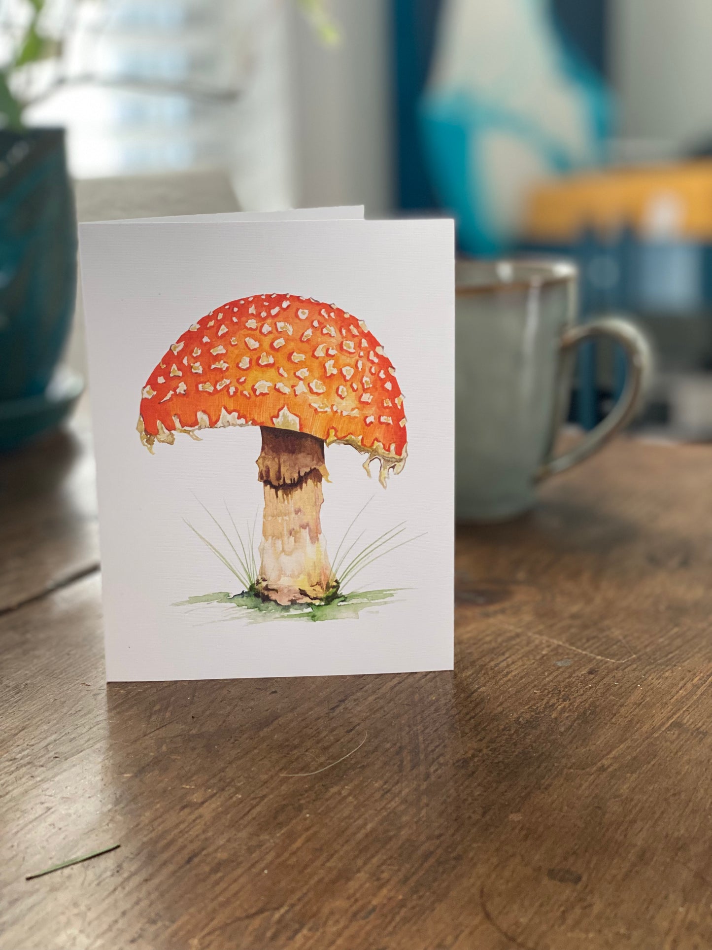 greeting card with watercolor painting of an orange mushroom. 