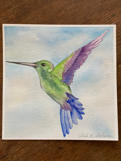 the original, signed painting of a hummingbird in flight. 