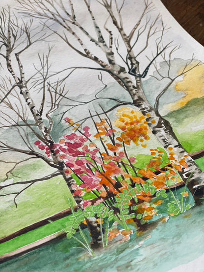 closeup of greeting card with painting of birch trees and fall foliage. 