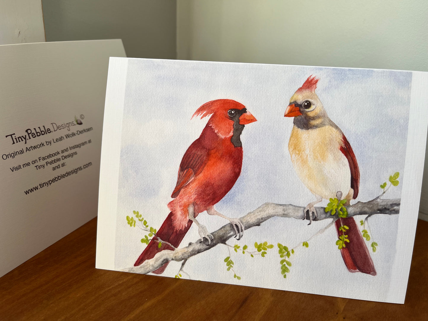 Greeting card with watercolor painting of a male and female cardinal sitting on a branch.