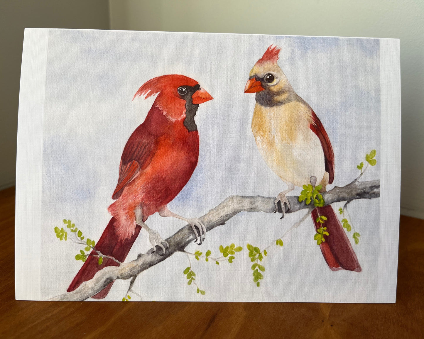 Greeting card with a painting of a male and female cardinal sitting on a branch.