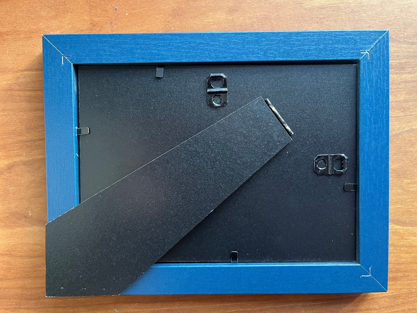 The back of a blue picture frame. 