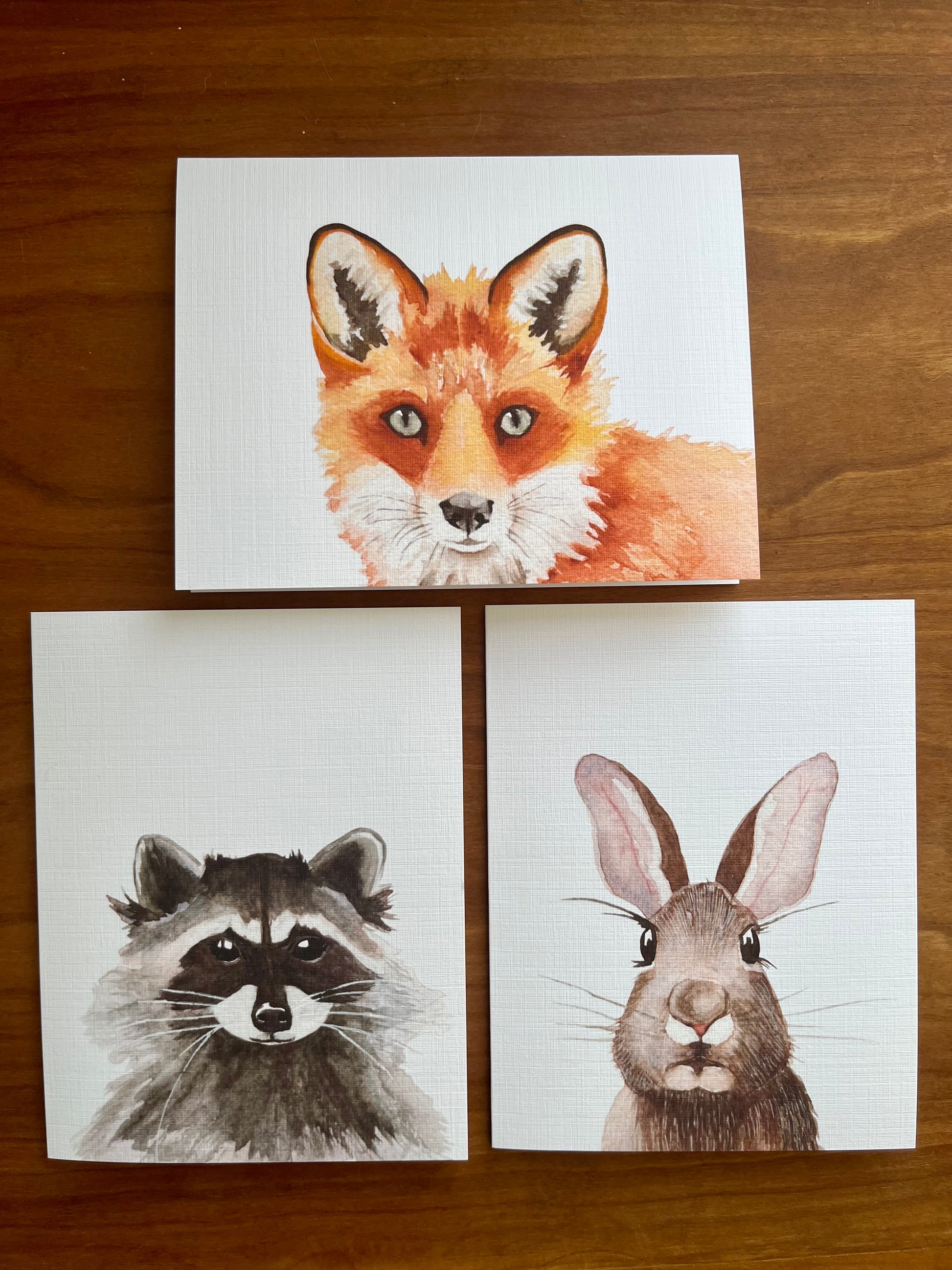 Set of three greeting cards with watercolor paintings of a fox, raccoon, and rabbit. 