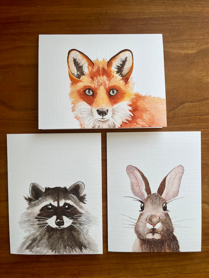 Set of three greeting cards with watercolor paintings of a fox, raccoon, and rabbit. 