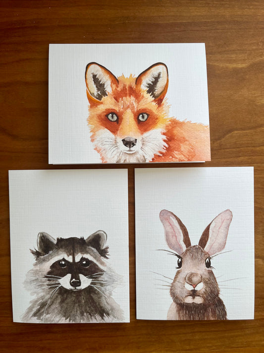 Set of three greeting cards with watercolor paintings of a fox, raccoon, and rabbit. 