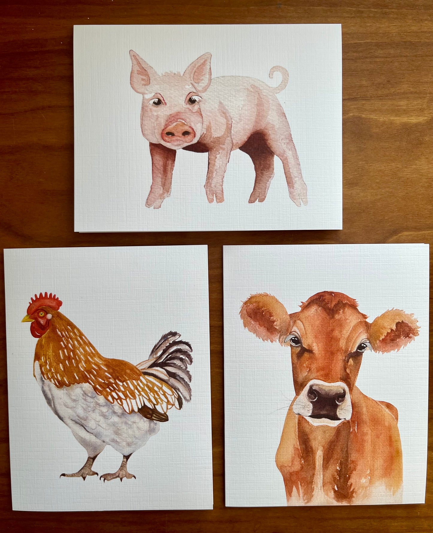 Set of three greeting cards with watercolor paintings of a pig, chicken and jersey cow. 