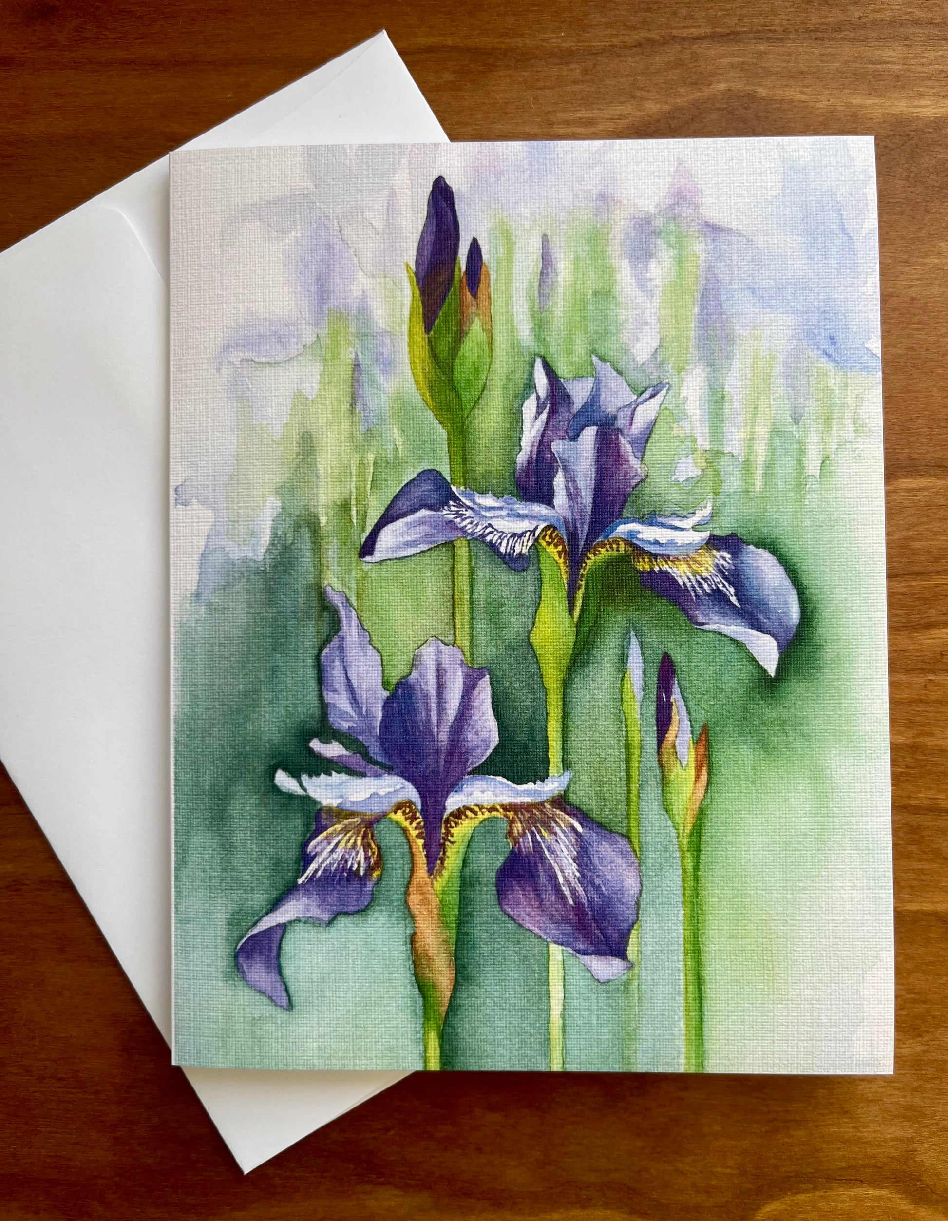 Greeting card with a watercolor painting of irises along with a white envelope. 