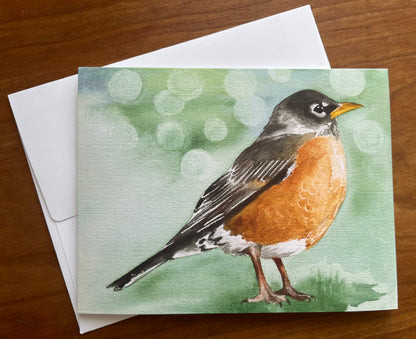 Greeting card with a watercolor painting of a robin along with a white envelope. 