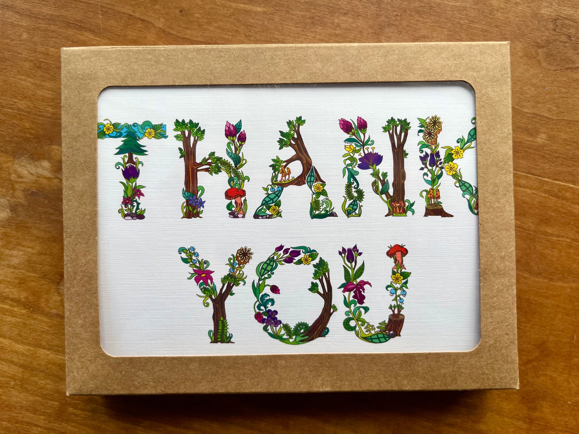 box of greeting cards with botanical letters spelling thank you.