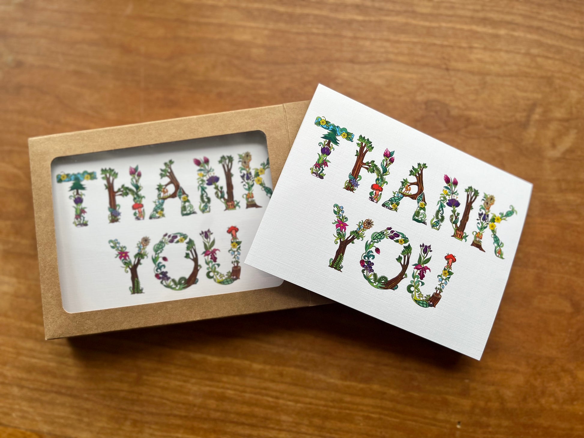 box of greeting cards with botanical letters spelling thank you.