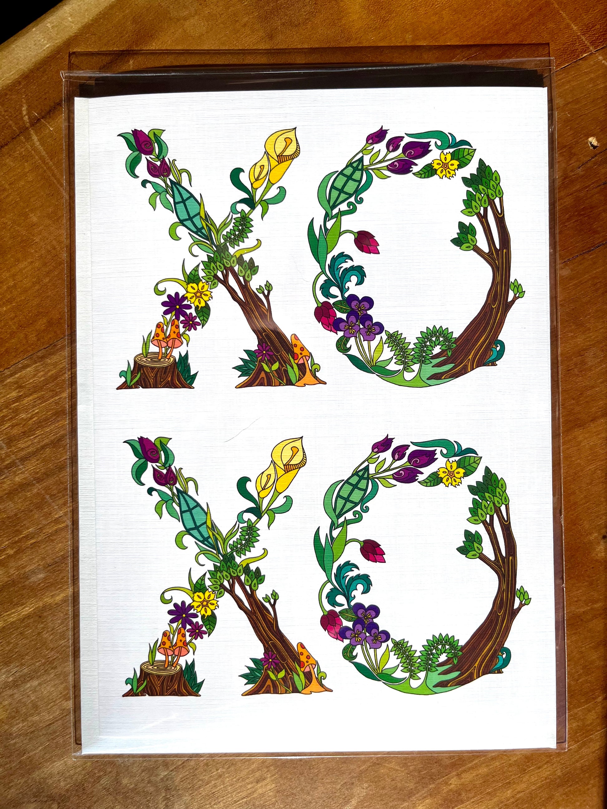 5x7 greeting card with botanical letters spelling out XOXO.