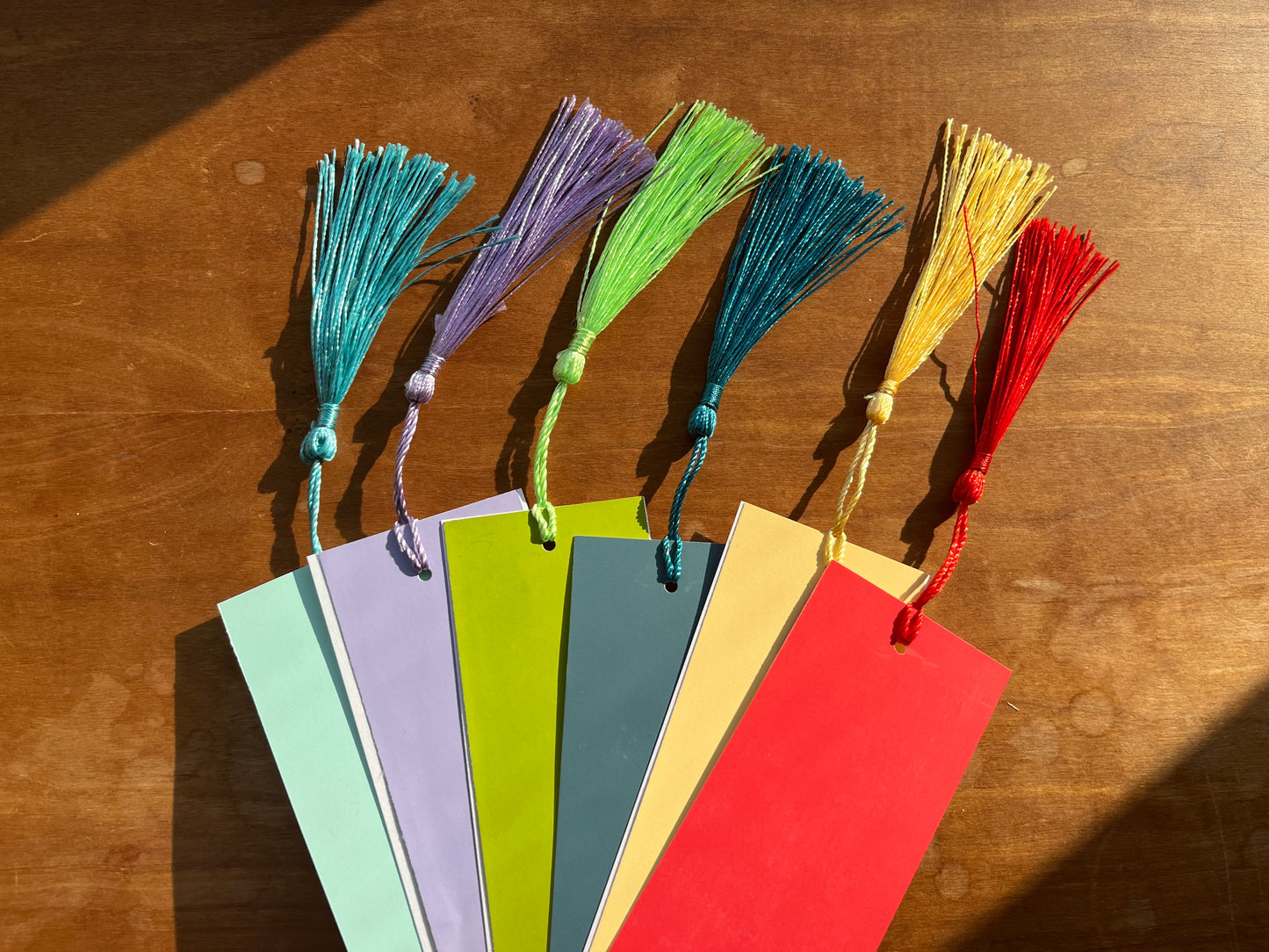 a collection of colorful bookmarks  with tassels.