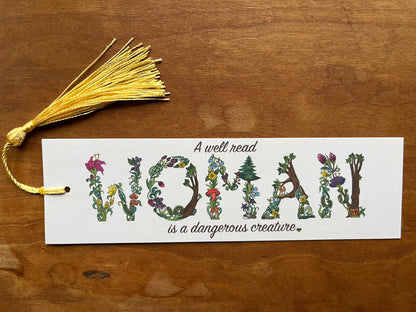 bookmark with botanical letters that says, "a well read woman is a dangerous creature".