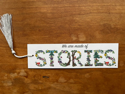 bookmark with botanical text that says, "we are made of stories".