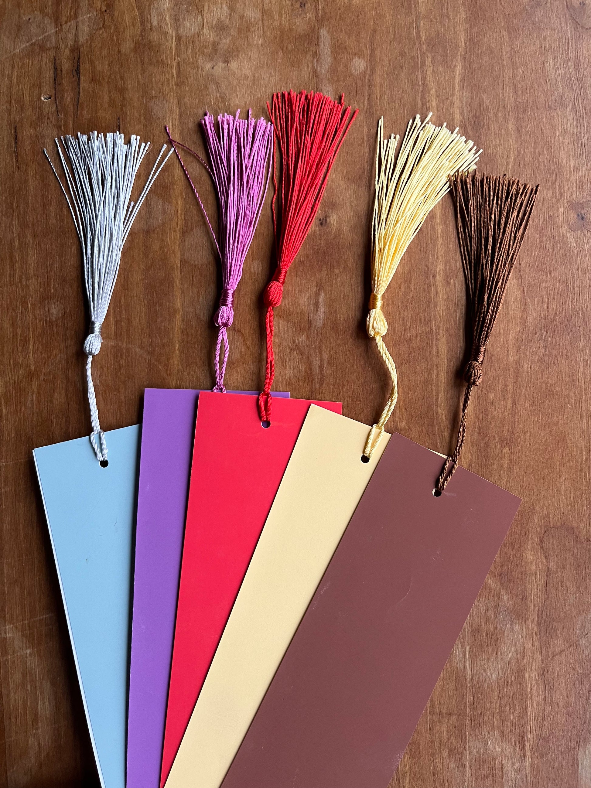 collection of colorful bookmarks with tassels.