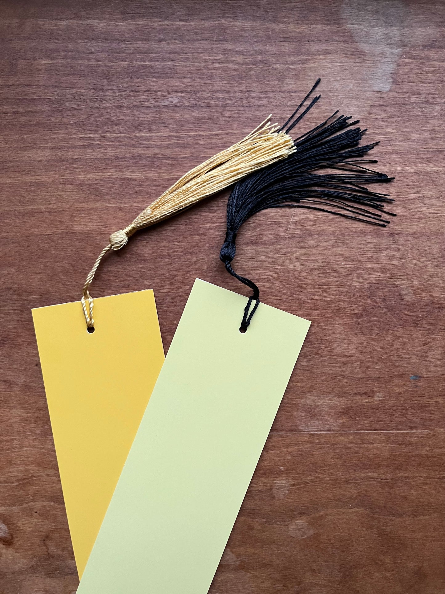 two yellow bookmarks with tassels.