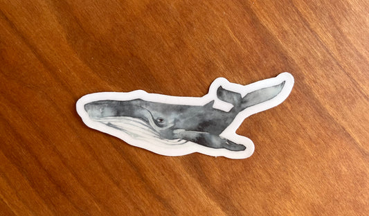 sticker with a watercolor painting of a whale.