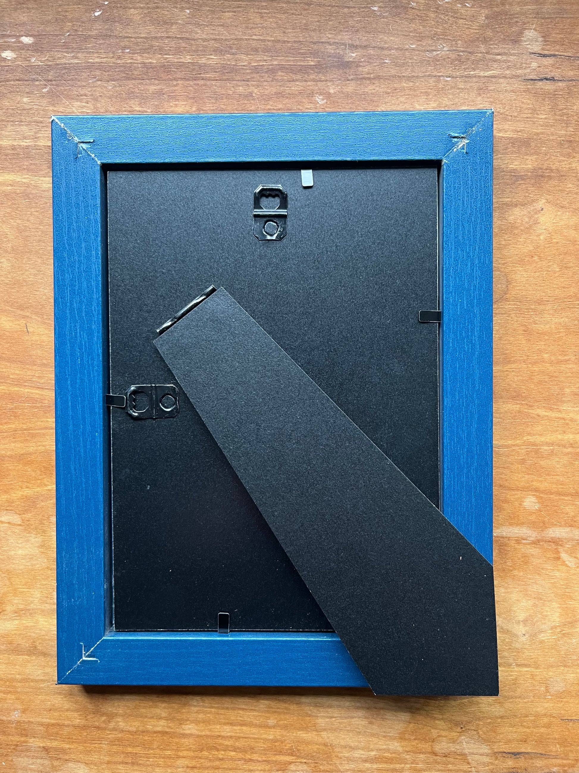 Back of a blue picture frame. 